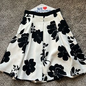 WHBM A-Line, midi skirt.  Off white with black flowers.  Size 14 petite